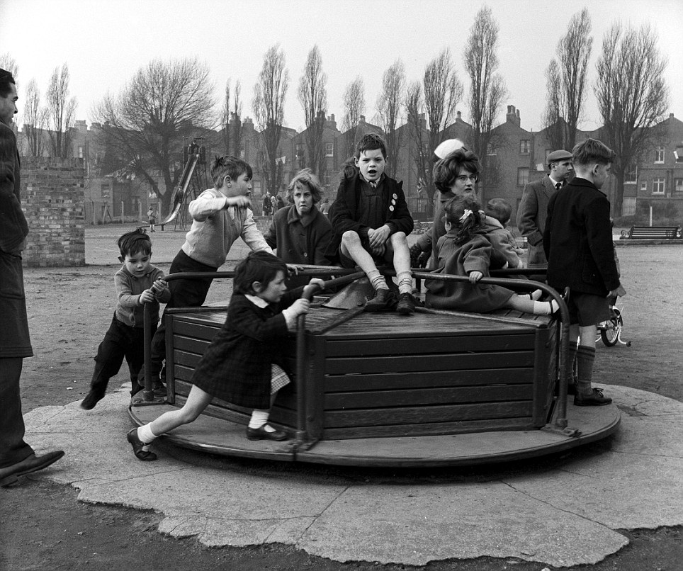 CHILDREN PLAYING IN PLAYGROUND - 1950S