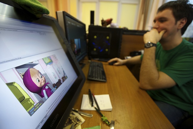 In this photo taken Wednesday, March 2, 2016, animator Andrei Belyayev works on a new episode of the Masha and the Bear cartoon series in Moscow, Russia. Masha and the Bear, a Russian animated television series launched in 2009, now broadcasts in more than 120 countries including the United States. Its YouTube channel is in the top 10 most-viewed worldwide. (AP Photo/Ivan Sekretarev)